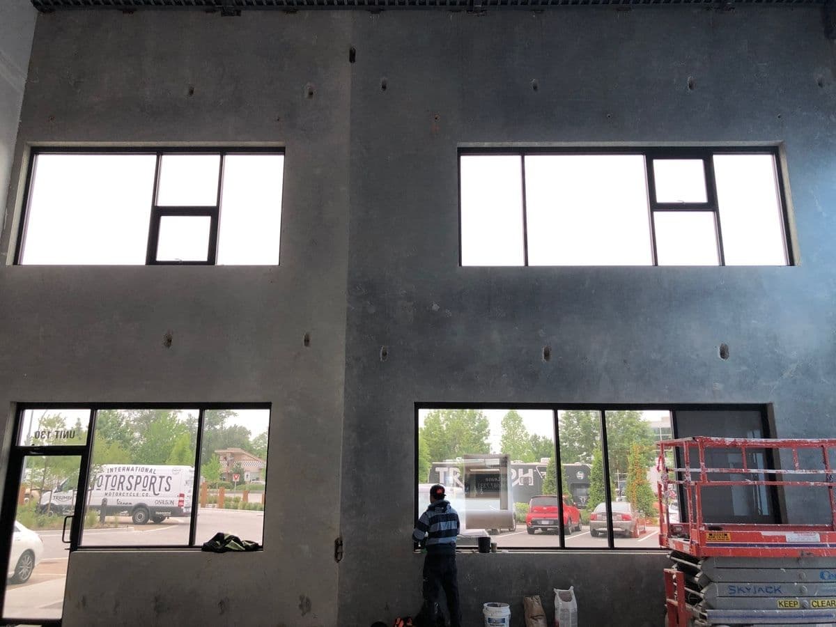 Interior view of tilt-up panel walls with the window openings being glazed