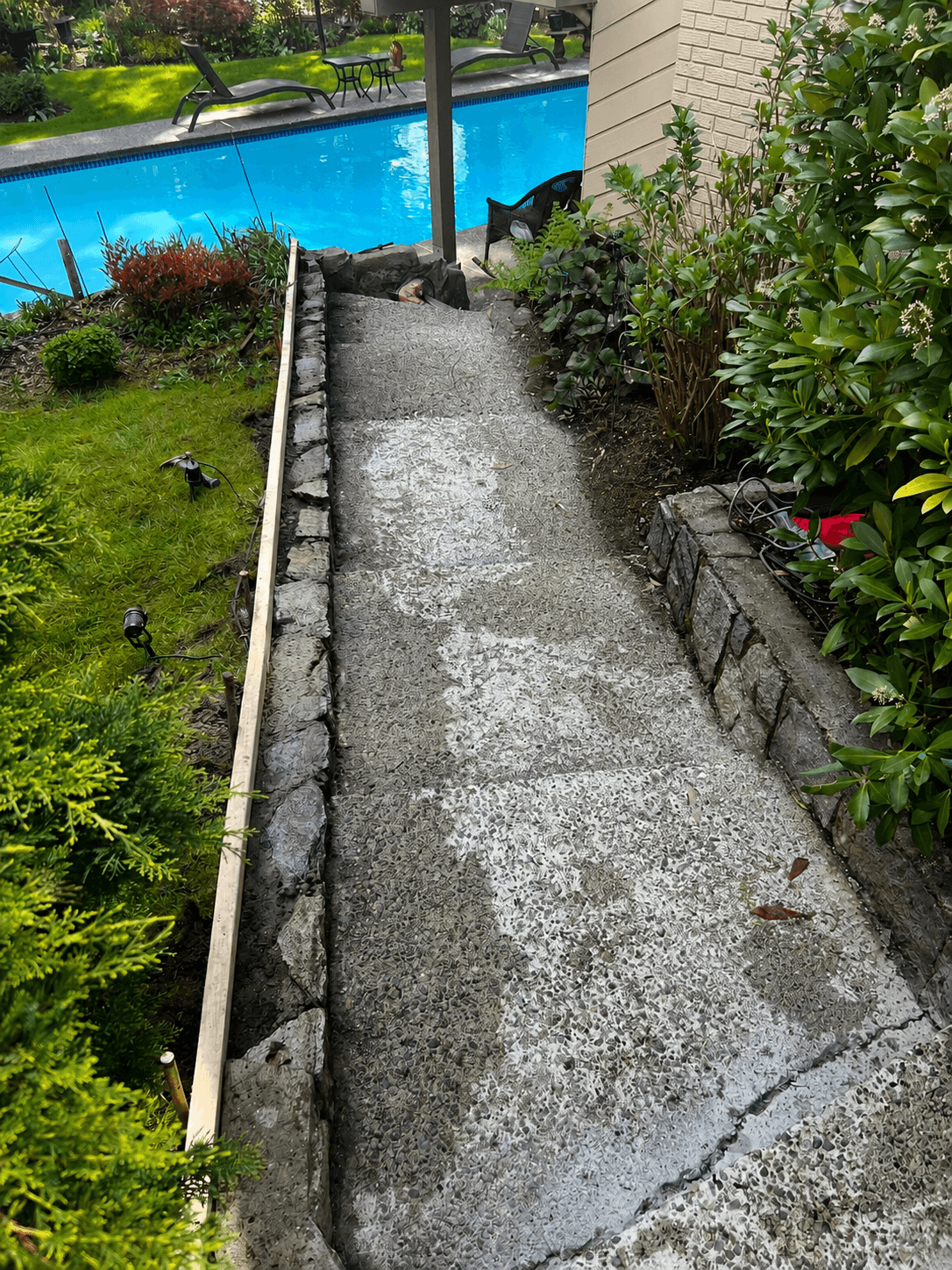 Worn stone poolside walkway — before