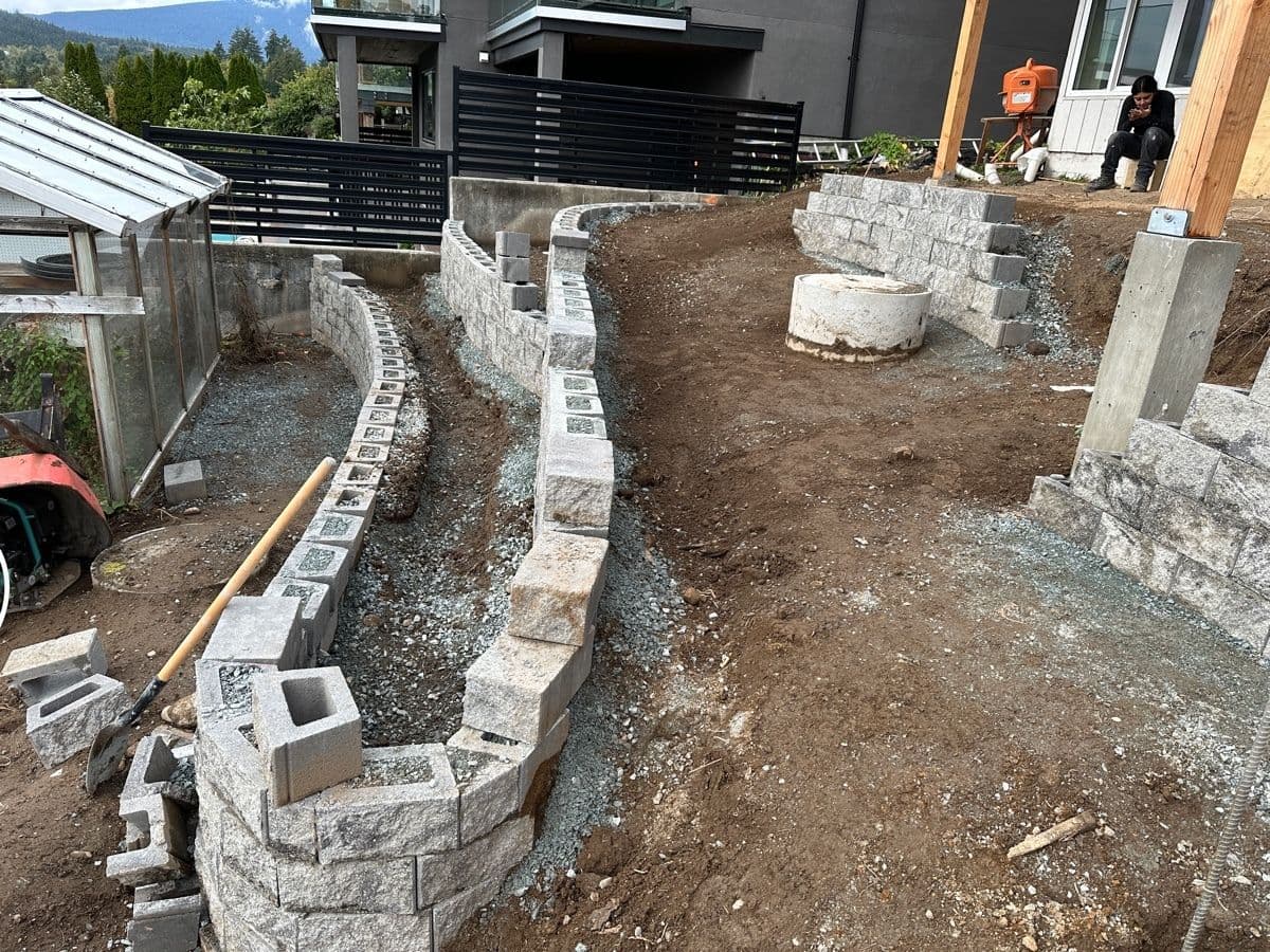 Curved retaining wall under construction with cast concrete piers