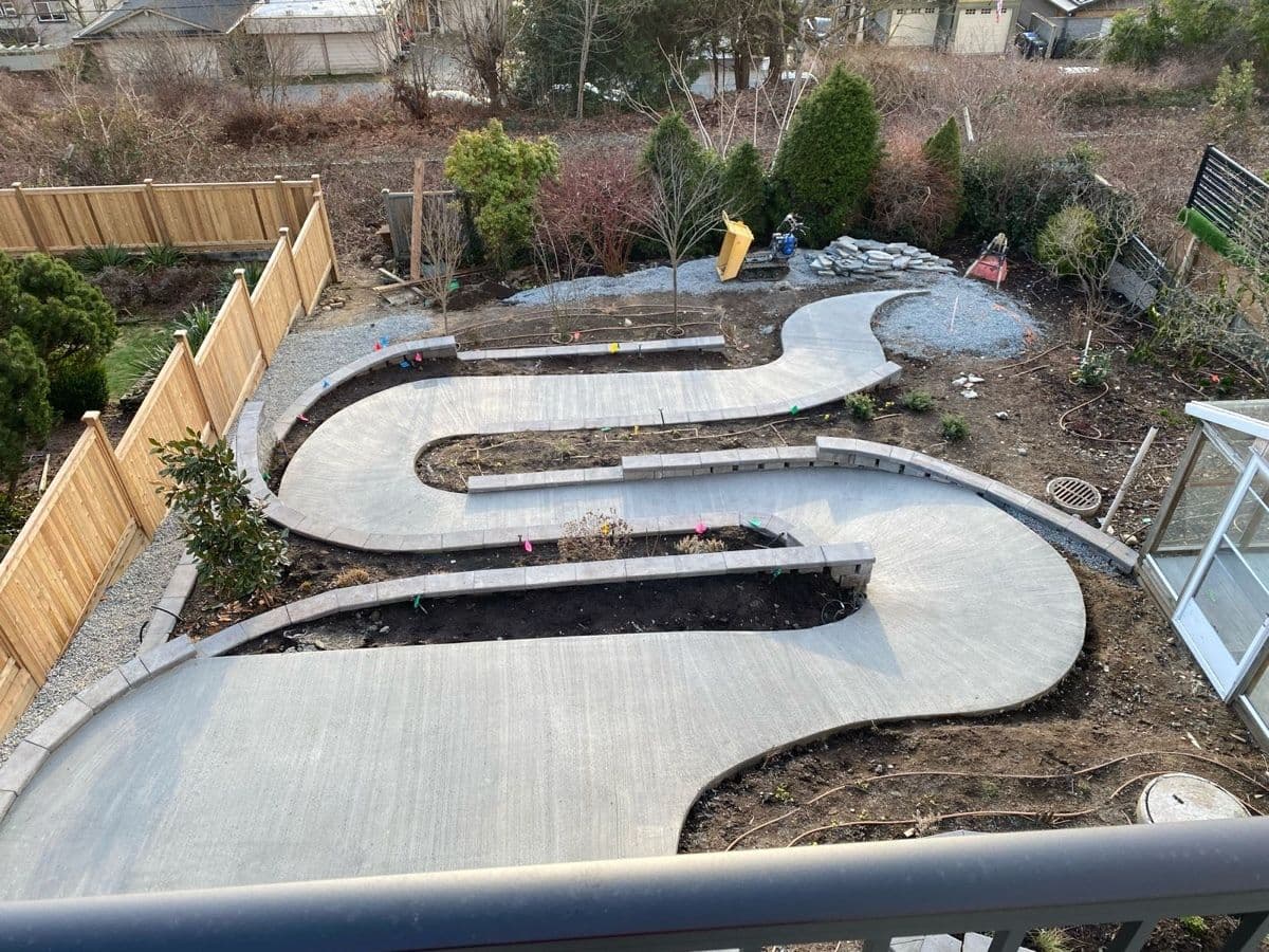 Aerial view of the finished curved concrete walkway and retaining wall planters
