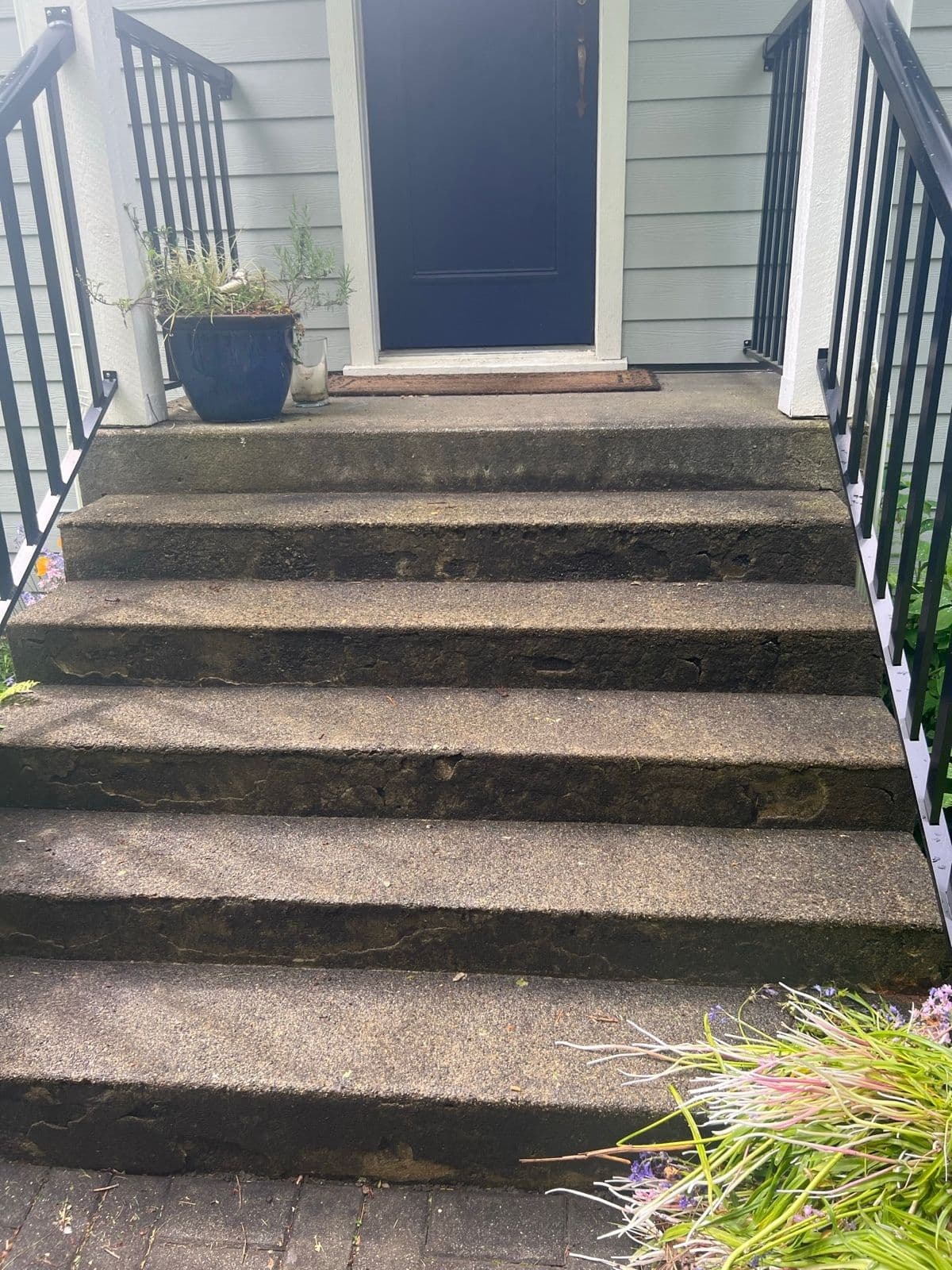 Worn, spalled front entrance concrete steps before restoration