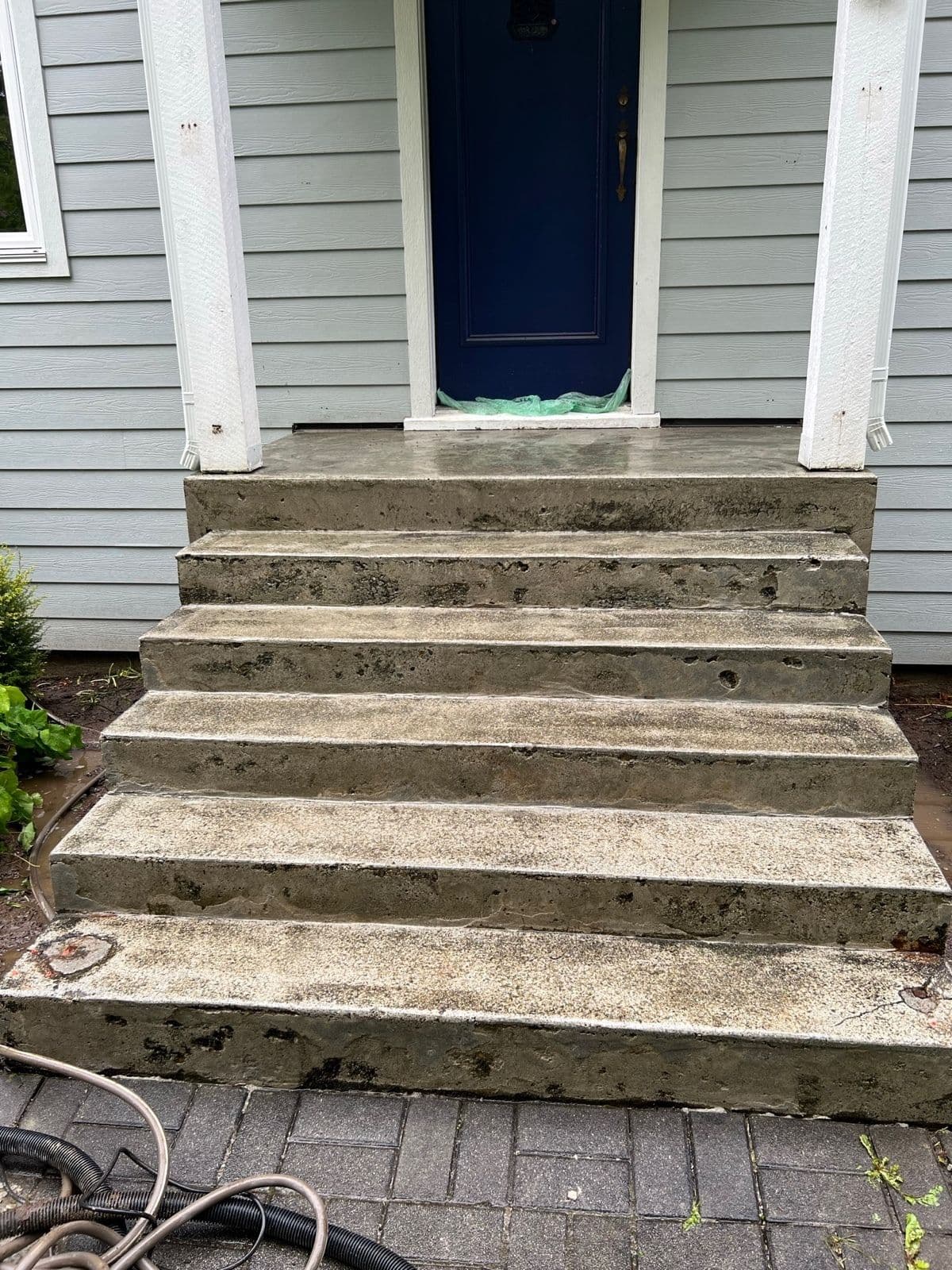 Front entrance steps pressure-washed and prepped for repair